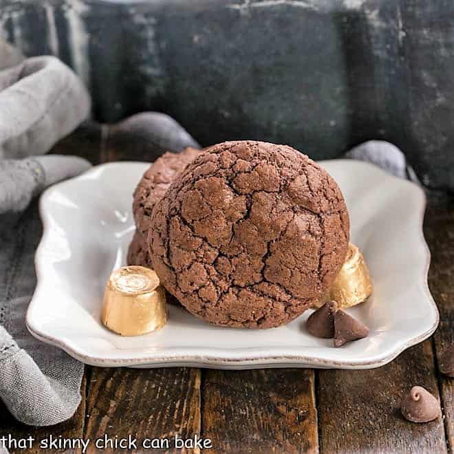 3 Rolo Brownie Cookies on a square white plate with Rolo Candies.