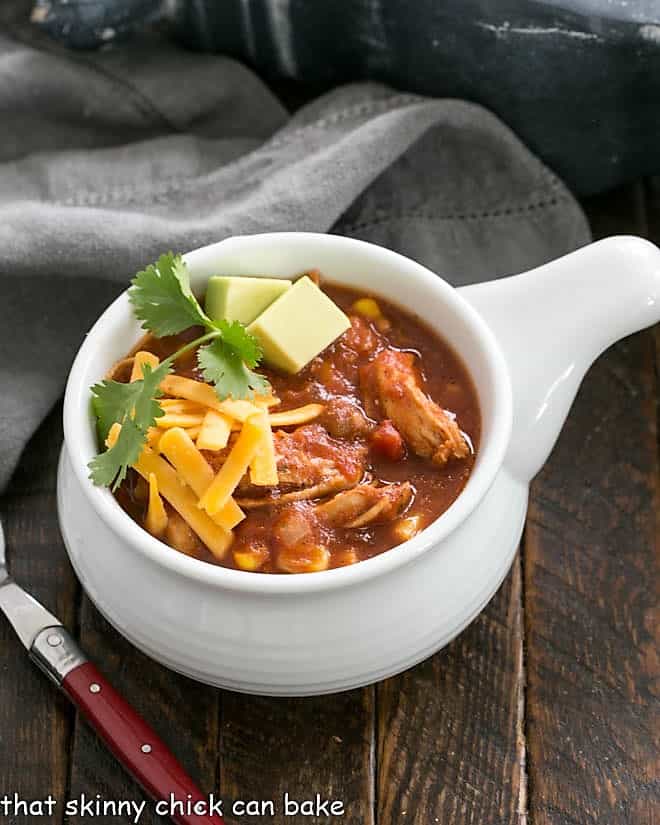 Overhead view of tortilla soup in a white soup bowl with a handle