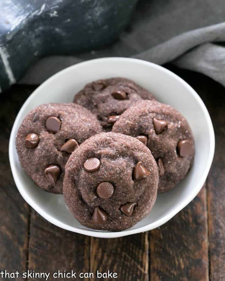 4 peanut butter filled chocolate cookies in a small white bowl.