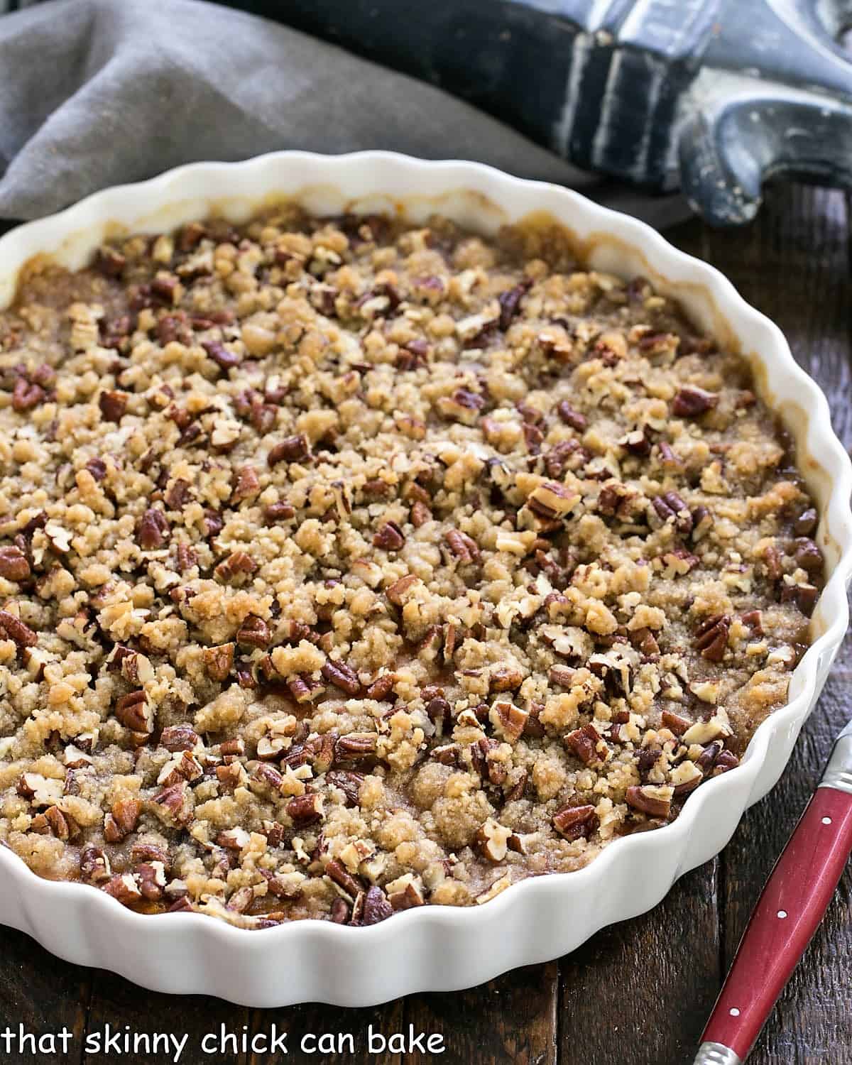 Overhead view of Praline Topped Sweet Potato Casserole in a white, round casserole dish.