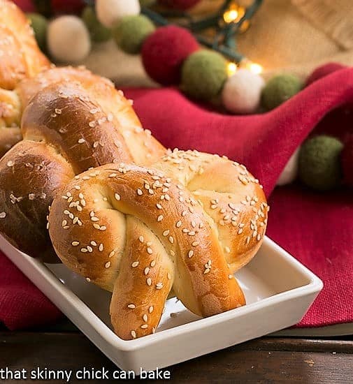 Homemade Challah Pretzels - Chewy pretzels made with eggy challah bread dough Homemade Challah Pretzels covered with sesame seeds on a white tray.