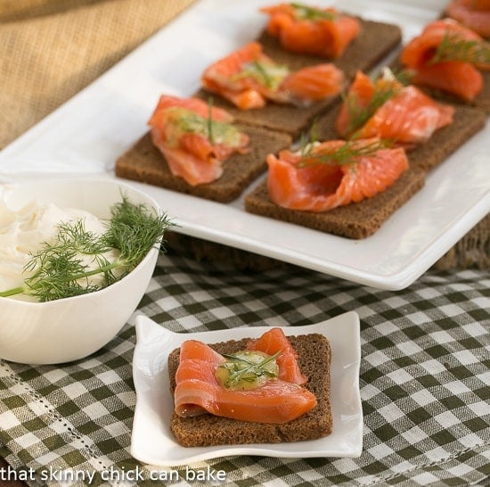 Dilled Gravlax with Mustard Sauce - a salt, sugar and dill cured salmon that's perfectly delectable! Dilled Gravlax with Mustard Sauce on rye cocktail bread with a dill garnish