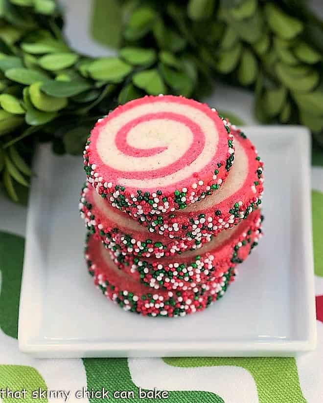 Holiday Pinwheel Cookies stacked on a square white plate