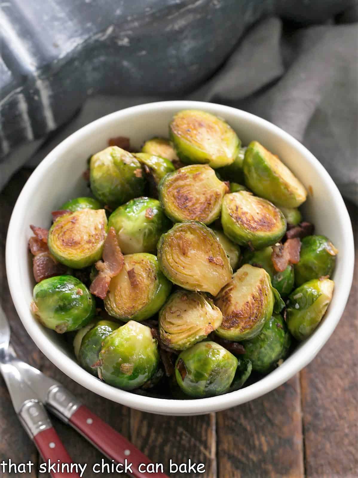 Overhead view of a bowl of sauteed brussels sprouts with bacon