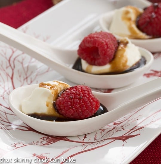 Balsamic Raspberries with Mascarpone Cream - Dessert tapas recipe that's super easy and will disappear in a flash! Closeup view Balsamic Raspberries with Mascarpone Cream in white Chinese soup spoons