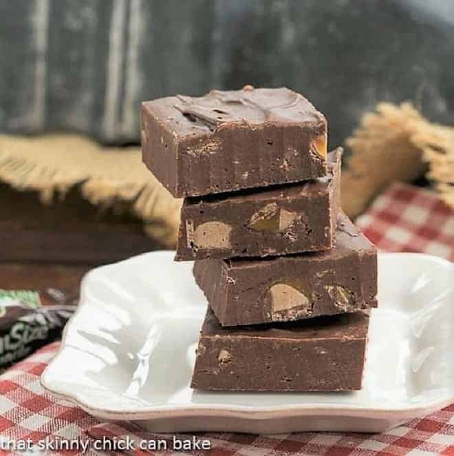 Milky Way Fudge squares stacked on a white dessert plate