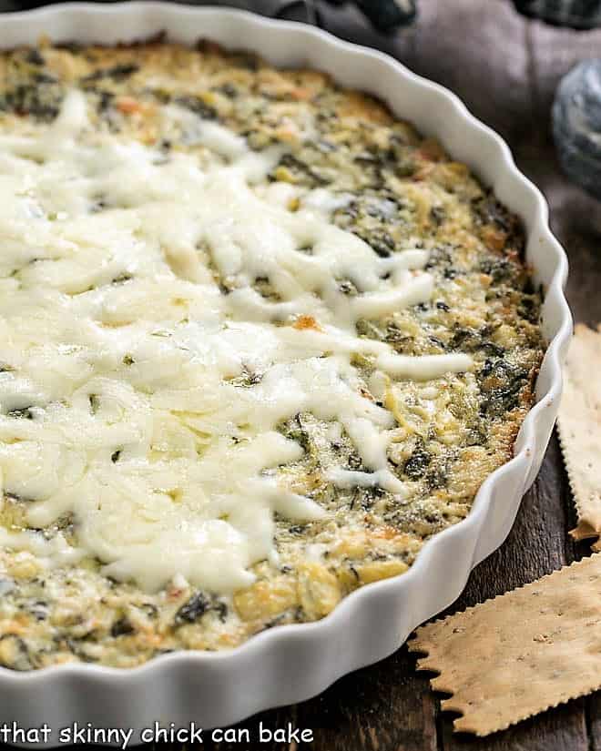 Spinach Artichoke Dip - A perennial party favorite Spinach and ARtichoke Dip in a casserole dish.