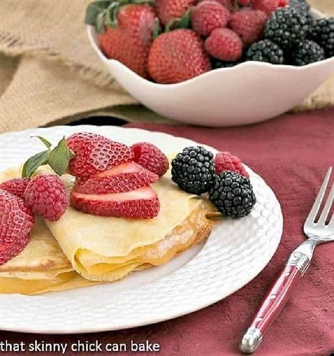Dessert Crêpes - Dosed with Grand Marnier and rum and filled with lemon curd, these are no ordinary crepes! Butter and Rum Crêpes filled with lemon curd and topped with fresh berries.