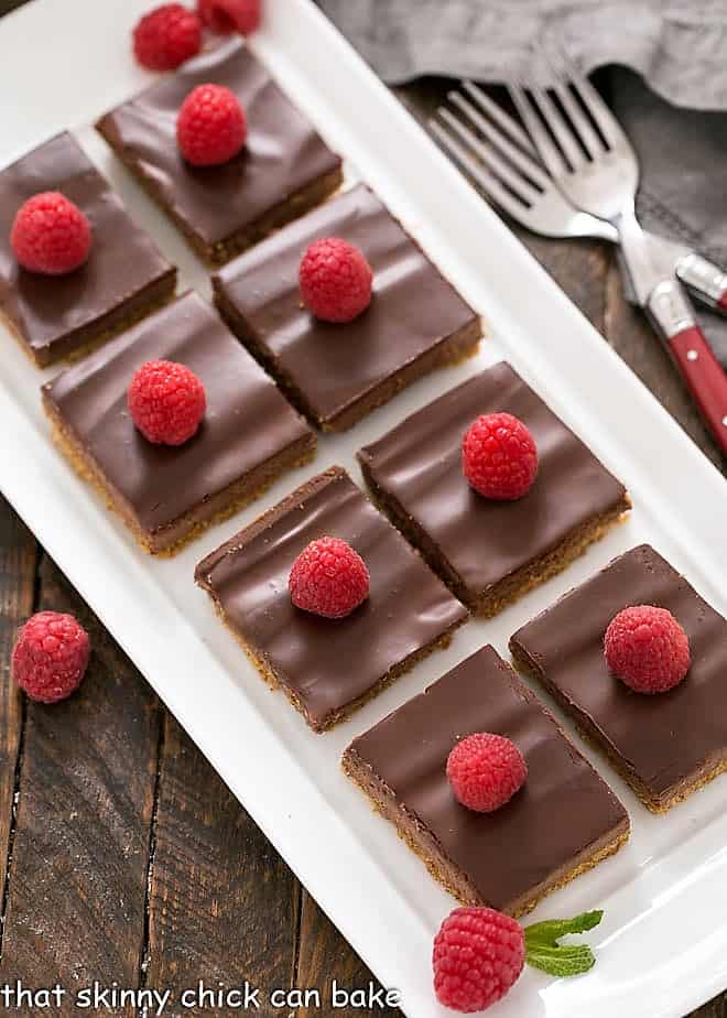 Dark Chocolate Mousse Bars - a chocolate dessert with a graham cracker crust, egg free dark chocolate mousse and a glossy ganache topping Overhead view of Dark Chocolate Mousse Bars on a white tray