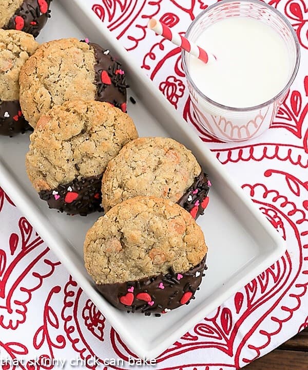 Overhead shot of Big Dipper Oatmeal Butterscotch Cookies on a red and white napkin with a glass of milk.
