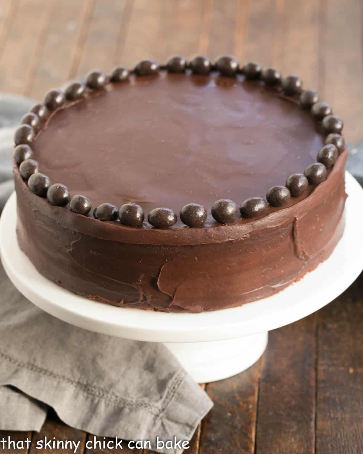 Mocha Brownie Cake on a white ceramic cake stand.