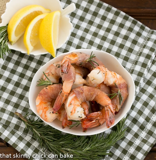 Rosemary Prosciutto Shrimp: Succulent, jumbo shrimp wrapped in prosciutto and flavored with rosemary and Sambuca! Rosemary Prosciutto Shrimp overhead view in a white bowl.