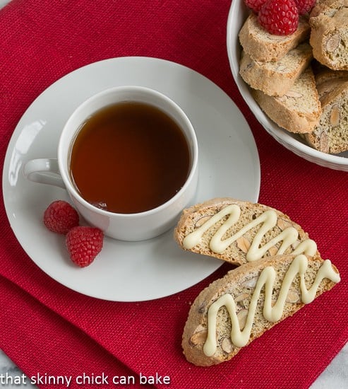 Overhead view of two Cantuciini or Almond Biscotti next to a cup of tea.
