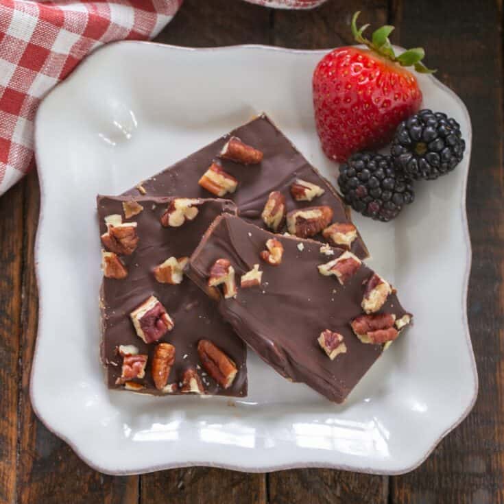 Matzo crack on a square white plate with berries.
