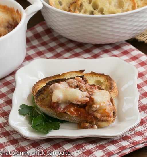 Lasagna Dip on toast on a square white plate