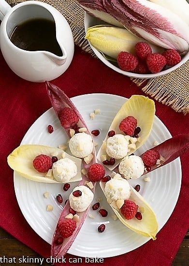 Overhead view of a star of Endive Cups with Blue Cheese, Raspberries and Macadamia Nuts.