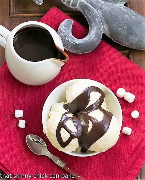 Fudge Topped Marshmallow Ice Cream - a delicious twist on the classic hot fudge sundae Overhead view of Fudge Topped Marshmallow Ice Cream Sunday with a pitcher of fudge sauce