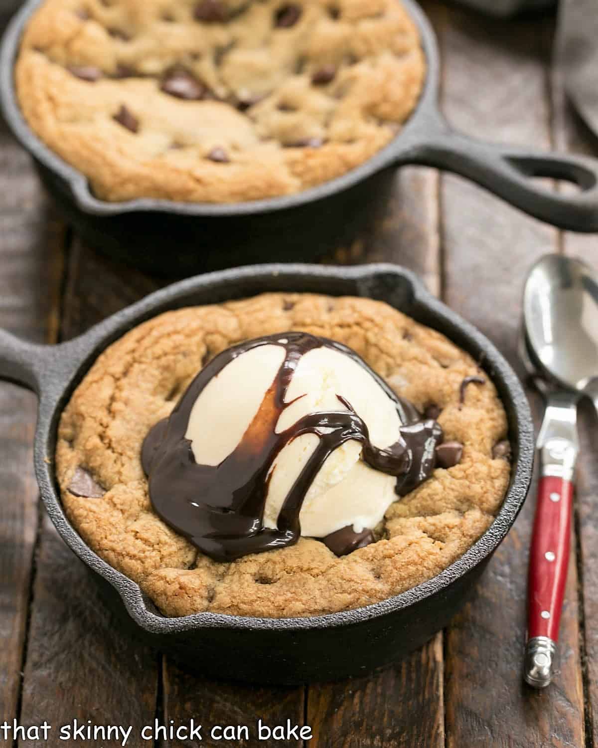 Pizookies - Big gooey pan cookies that are a cross between cookies and pan pizza! Big pizza cookiesa cast iron skillets with one topped with ice cream.