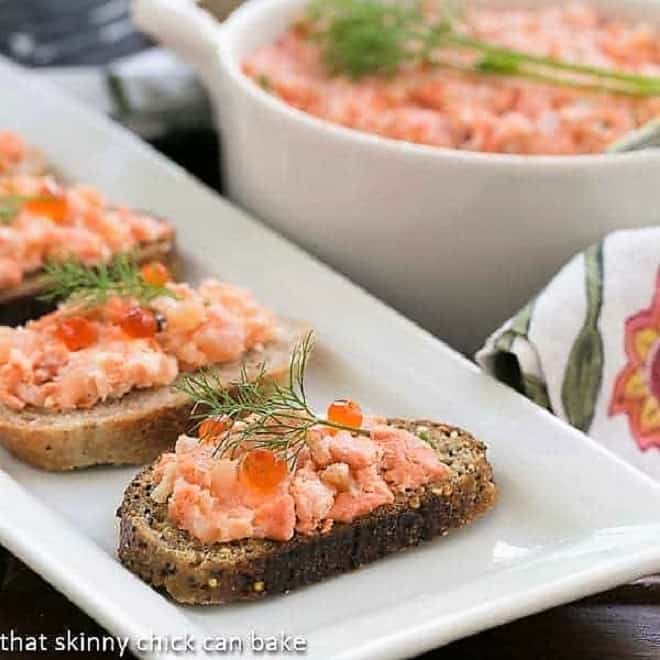 Salmon Rillettes on toasts on a white platter.