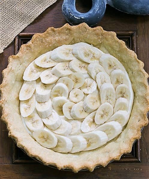 Banana Cream Cheesecake Pie with crust and layer of bananas.