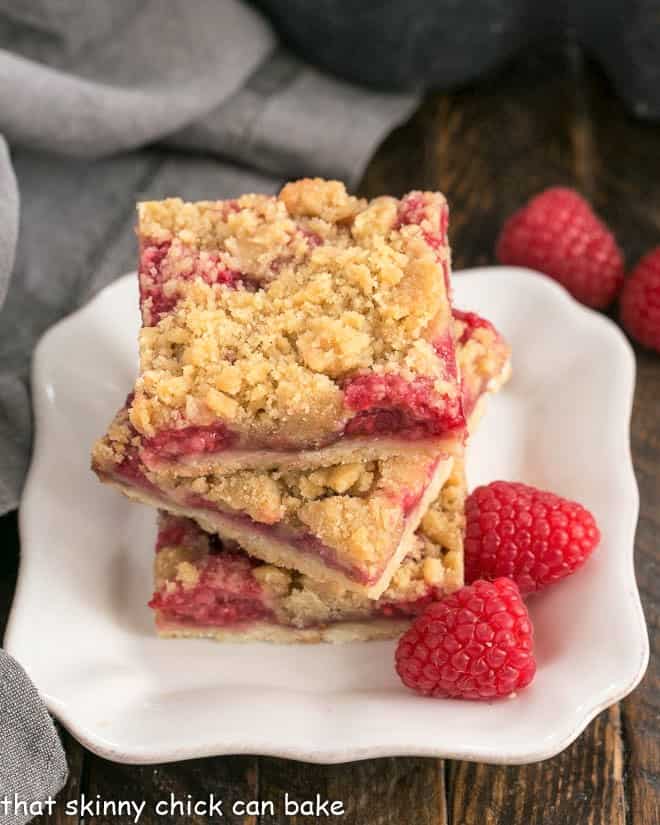 Streusel Topped Raspberry Squares on a small square white plate.