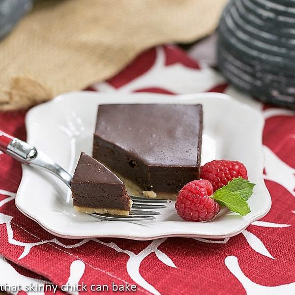 3 Truffle Brownies stacked on a white plate.