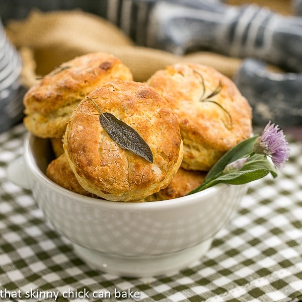 Herbed Buttermilk Biscuits in a bowl with a fresh herb garnish.
