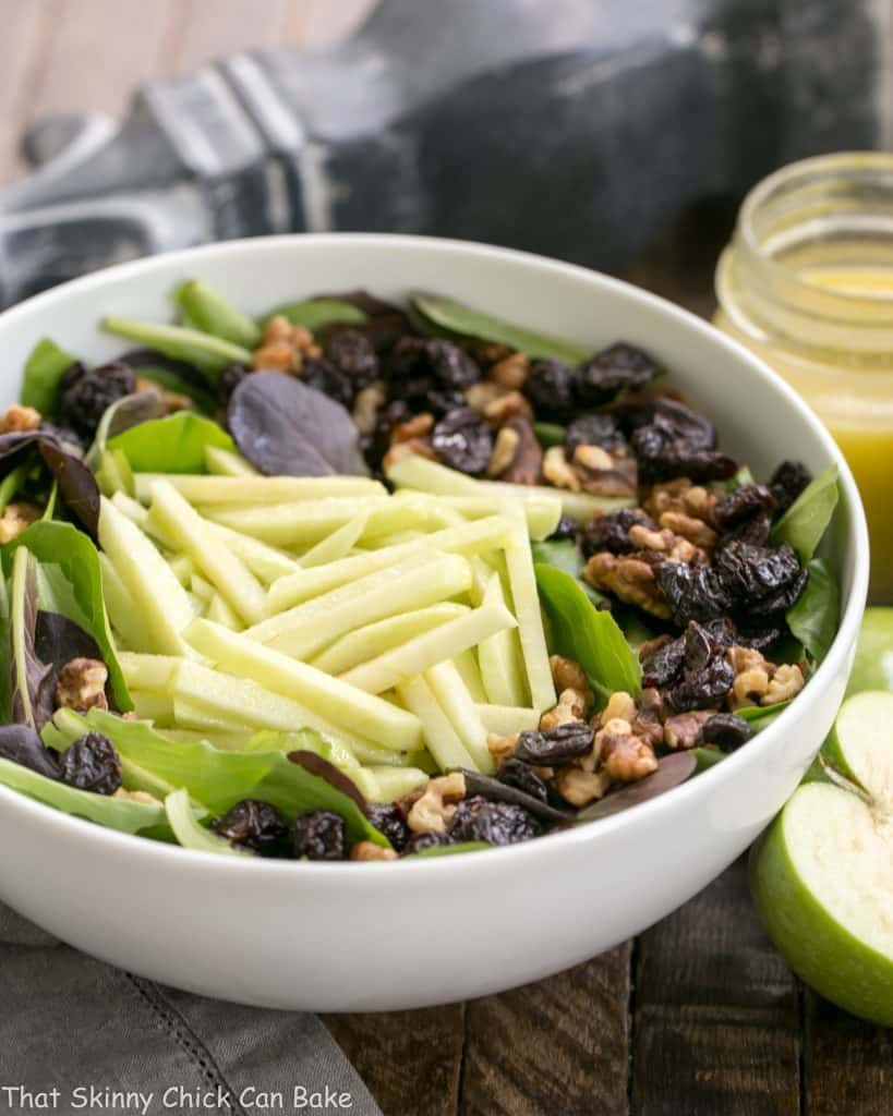 Apple, Cherry, Walnut Salad with Maple Dressing in a white serving bowl