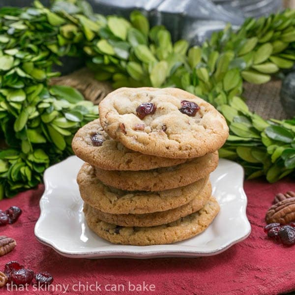Cranberry, White Chocolate, Crystallized Ginger Cookies - A star studded cookie that's perfect for the holidays and all year long! Cranberry, White Chocolate, Crystallized Ginger Cookies stacked on a white plate.
