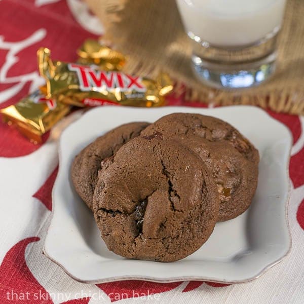 Three Double Chocolate Twix Cookies on a square white plate