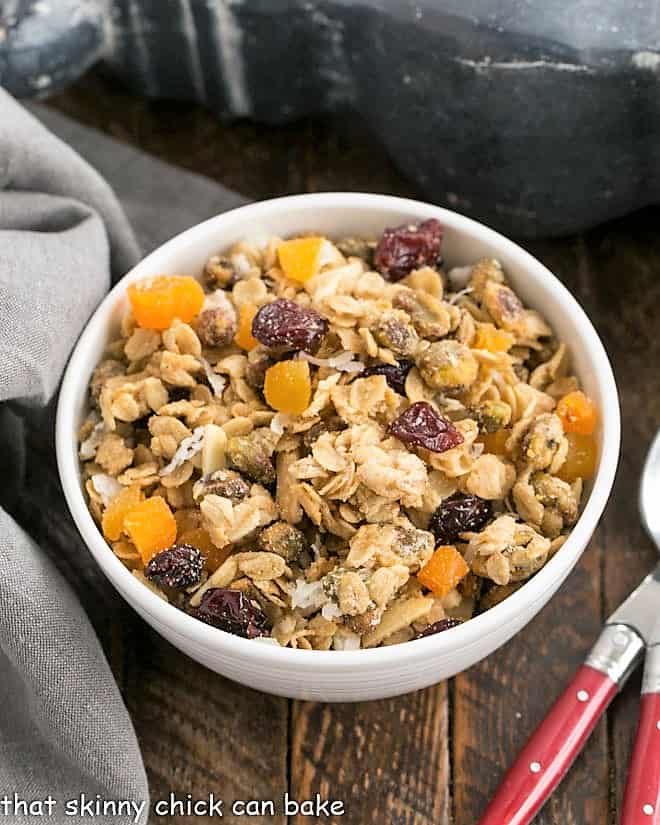 Pistachio Coconut Granola - a scrumptious homemade granola recipe that's perfect with milk, to top your yogurt or as a snack! Overhead view of Pistachio Coconut Granola with 2 spoons