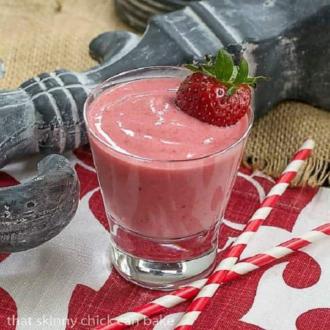 Berry Smoothie topped with a ripe strawberry.
