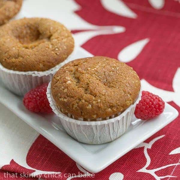 Cream Cheese Filled Pumpkin Muffins on a narrow white tray over a red and white napkin.