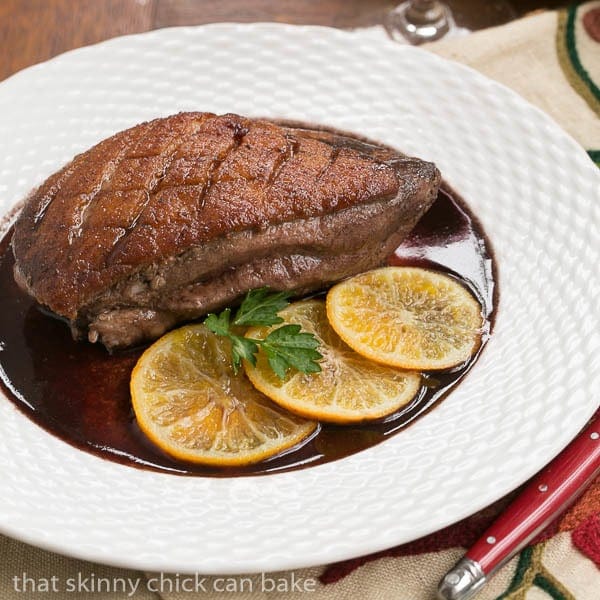 Pan Seared Duck Breasts on a white basketweave plate.