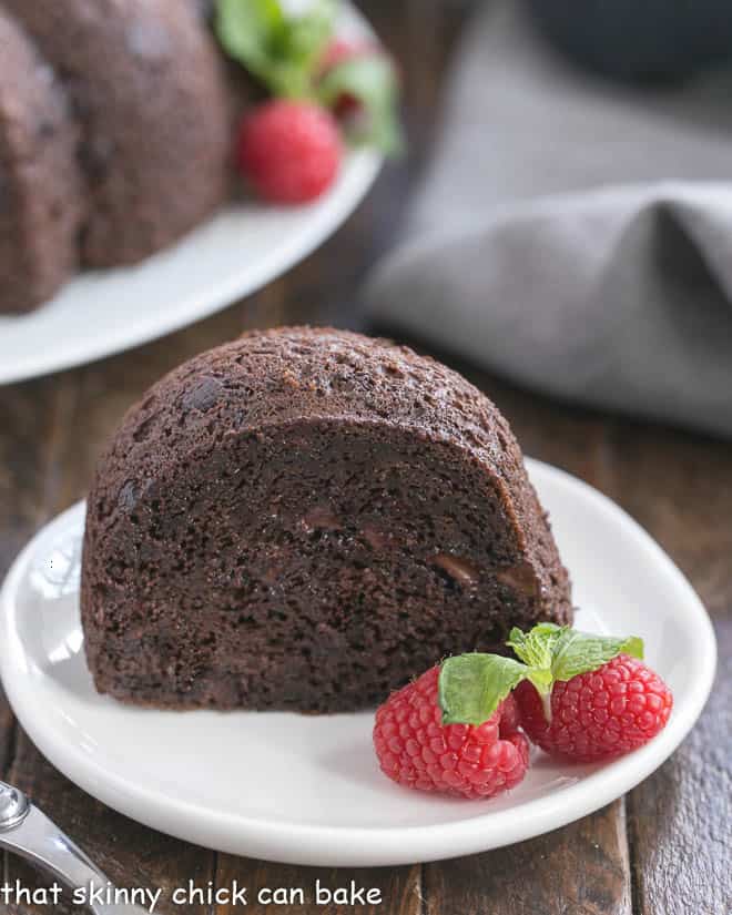 Slice of Chocolate Kahlua Cake with whole cake in the background.