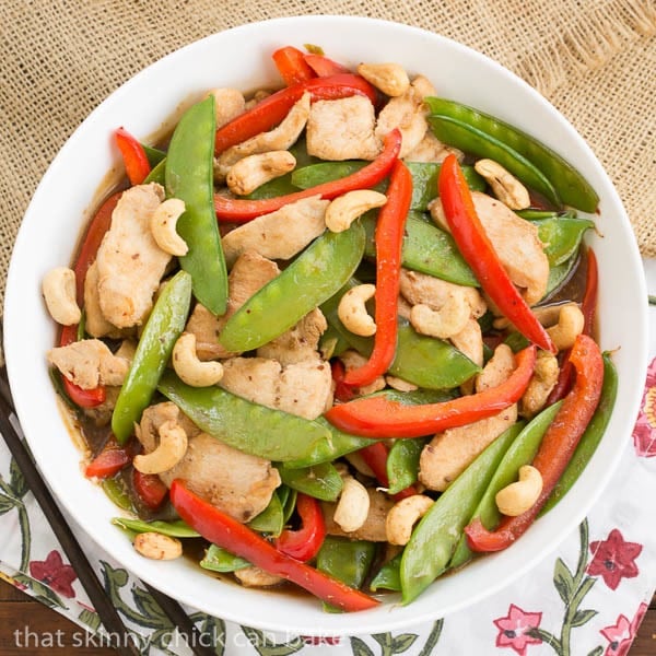 Overhead view of stir fried Cashew Chicken in a white serving bowl