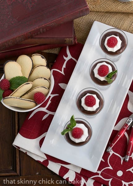 Double Chocolate Pudding - Creamy, luscious comfort food Overhead view of double Chocolate Pudding in glasses on a white rectangular tray.