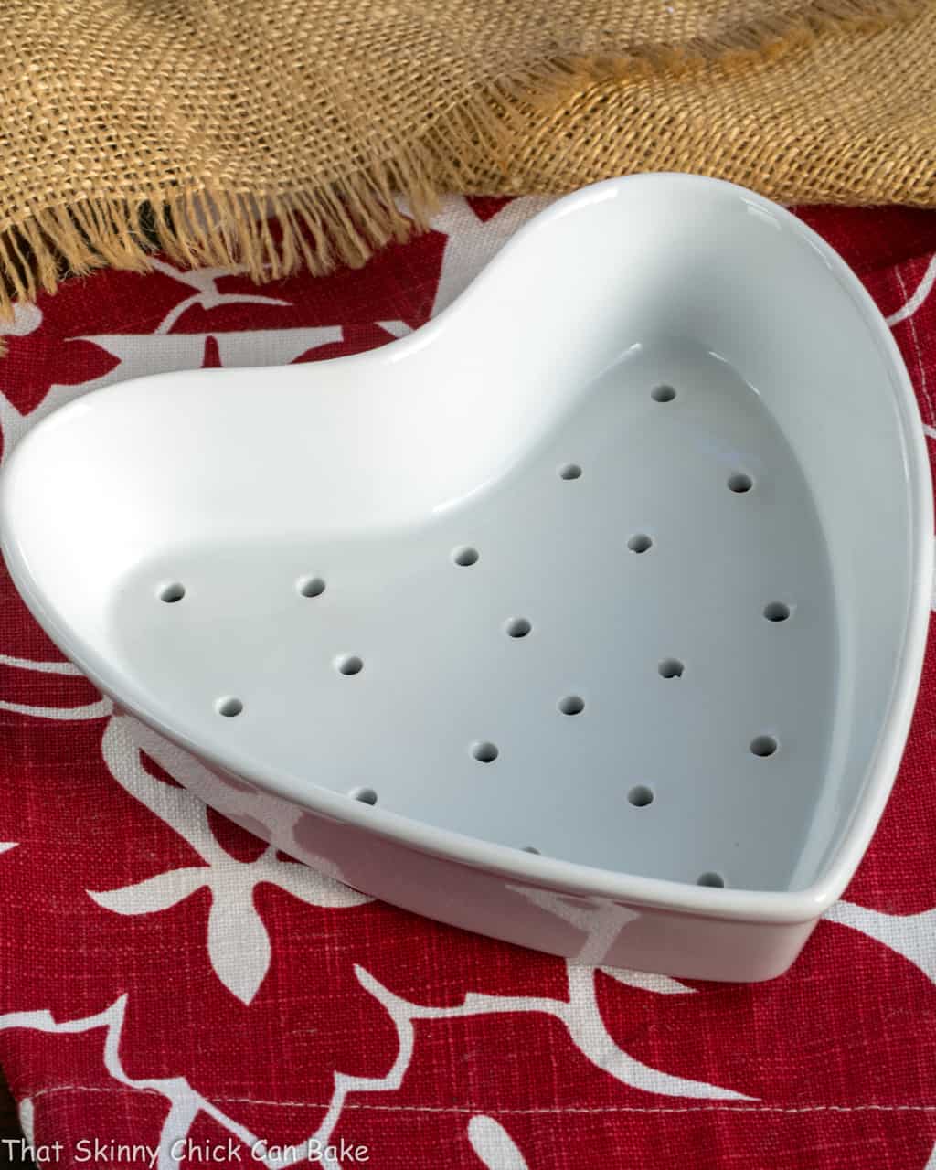 Chocolate Coeur a la Creme - This creamy heart-shaped dessert is the epitome of Valentine's Day sweets! Chocolate Coeur a la Creme mold on a red and white napkin.