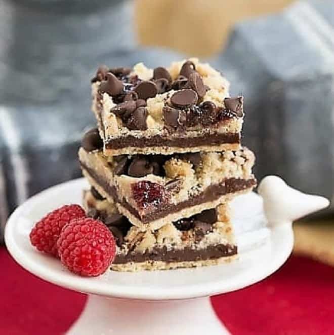 Chocolate Raspberry Crumb Bars on a small white pedestal.