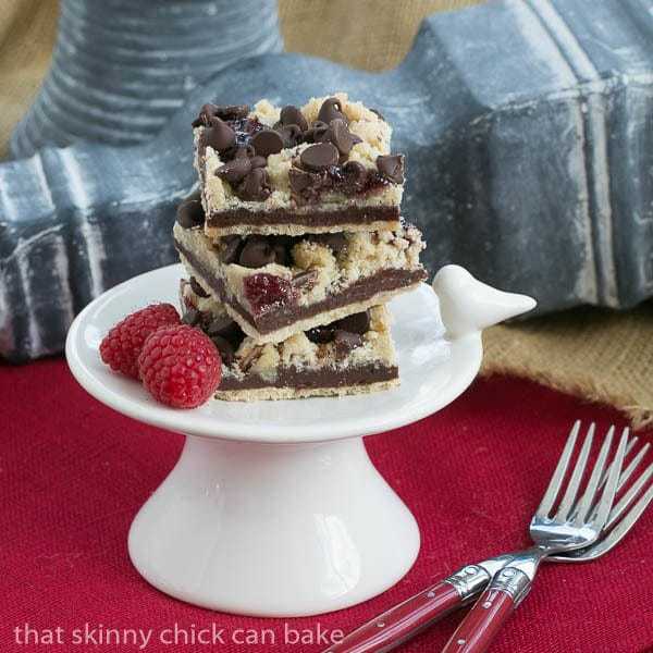 Chocolate Raspberry Crumb Bars on a small white pedestal.