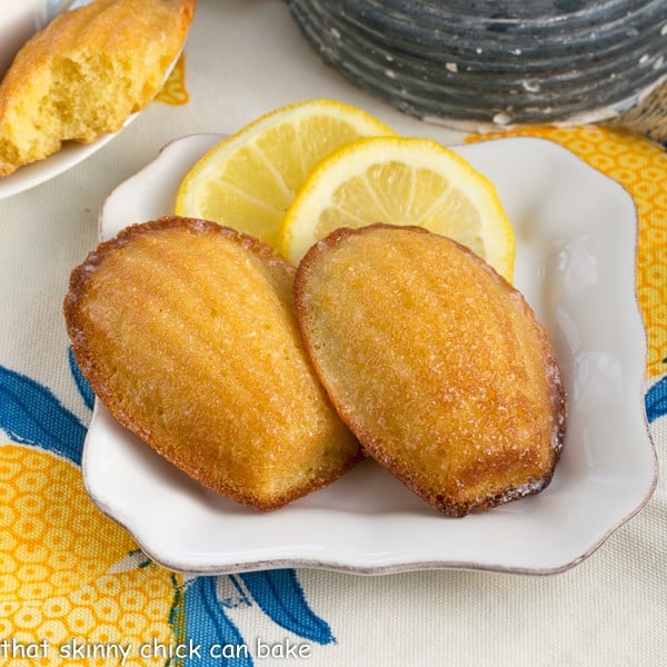 Lemon Madeleines on a square white ceramic plate.