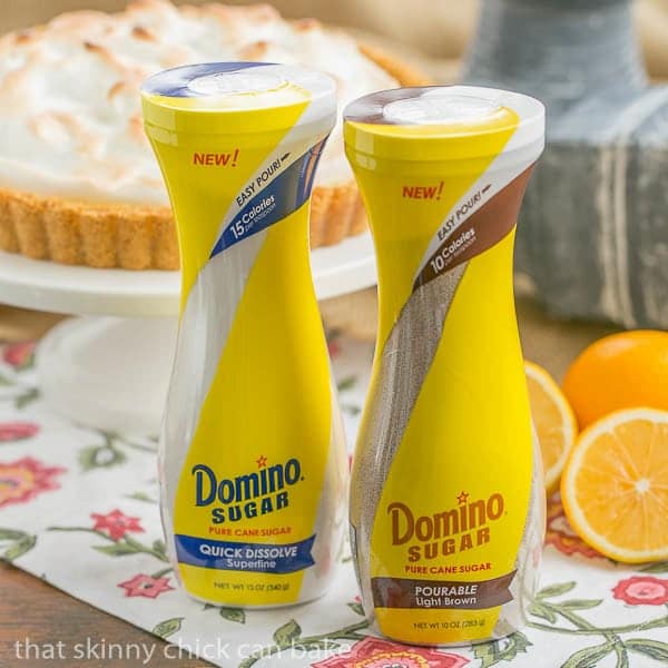 Meyer Lemon Tart with Meringue Topping with pourable Domino sugar containers in the foreground.