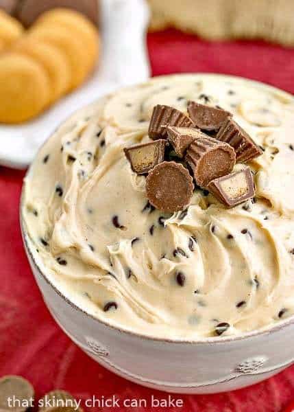 Tagalong Dip in a white serving bowl topped with mini Reese's peanut butter cups.