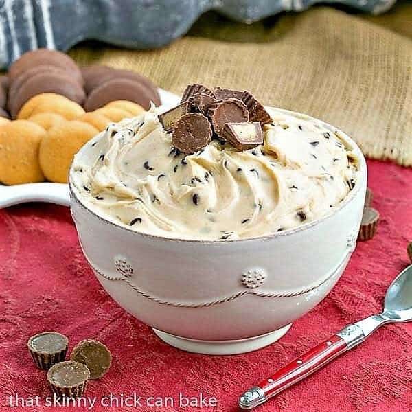 Peanut Butter Tagalong Dip in a ceramic bowl with a red handled spoon.