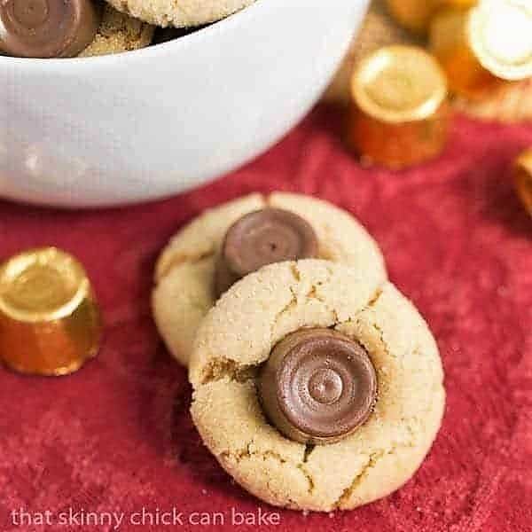 Rolo Peanut Blossoms - Sugar coated peanut butter cookies topped with a chocolate caramel Rolo Rolo Peanut Blossoms on a red napkin.