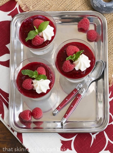 Overhead view of Raspberry White Chocolate Cheesecake Parfaits on a silver tray.