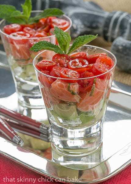 Easy Salmon Tartare in two glasses with a herb garnish.