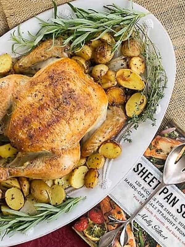 Roast sheetpan chicken on an oval white serving platter.
