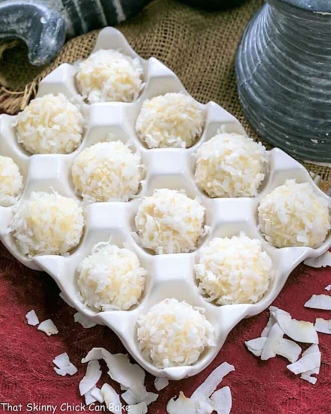 Coconut White Chocolate Truffles - An easy, decadent 4 ingredient recipe! Perfect for gifts! Coconut White Chocolate Truffles in a ceramic egg crate.