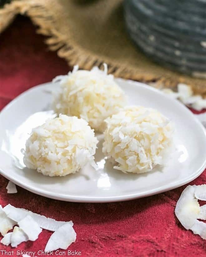 Coconut White Chocolate Truffles - An easy, decadent 4 ingredient recipe! Perfect for gifts! Coconut White Chocolate Truffles on an oval white plate.